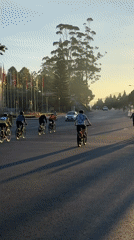 Cyclists ride lakeside roads in Da Lat Vietnam