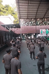 Uniformed groups exercise and move through a Malang campus