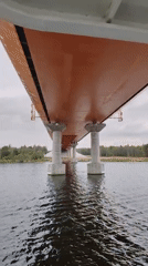 Orange bridge documented from water level in Russian river region