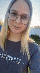 Woman records walking selfies on sunny tree-lined street