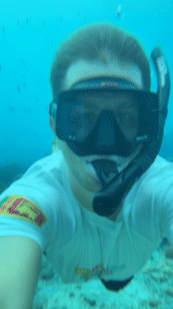 Snorkeler documents vibrant coral reef marine life in Nusa Penida