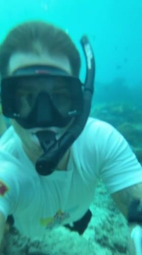 Snorkeler documents vibrant coral reef marine life in Nusa Penida