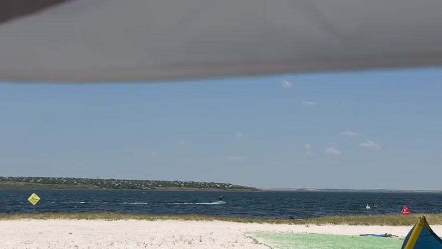 Kiteboarding on a sunny summer morning near Ukrainka