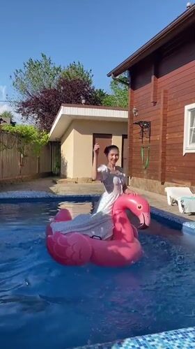 Women enjoy sunny afternoon at residential pool in Dagomys