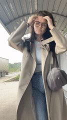 Woman waits at bus stop in Molokovo, Russia