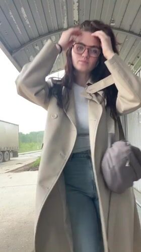 Woman waits at bus stop in Molokovo, Russia