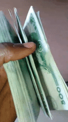 Person displays stack of Nigerian N500 banknotes
