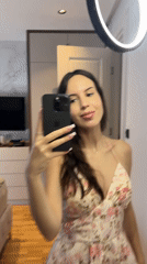 Woman documents morning routine with bedroom mirror selfies
