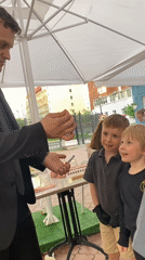 Street magician entertains children with card tricks in Yekaterinburg