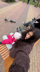 Family enjoys playground time on swings in Krasnogorsk