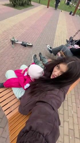 Family enjoys playground time on swings in Krasnogorsk
