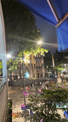 Evening activity captured around illuminated St. Joseph's Cathedral, Hà Nội