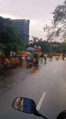 Everyday street life documented across Dhaka during rainy midday