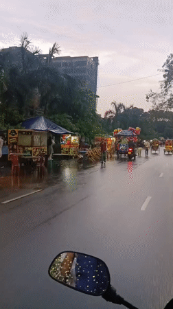 Everyday street life documented across Dhaka during rainy midday