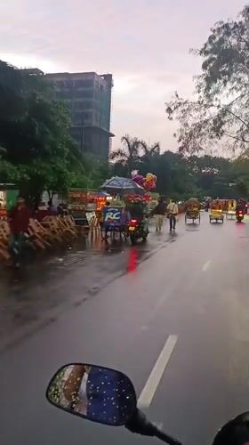 Everyday street life documented across Dhaka during rainy midday