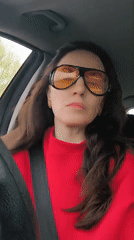 Woman in red observed driving and meditating during morning hours