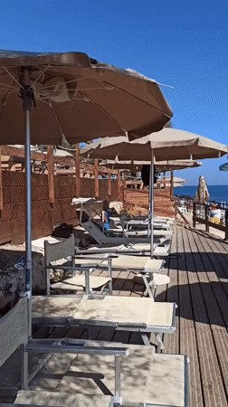 Summer morning at a rocky beach club in Molfetta