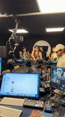 Four people recorded in podcast studio with microphones