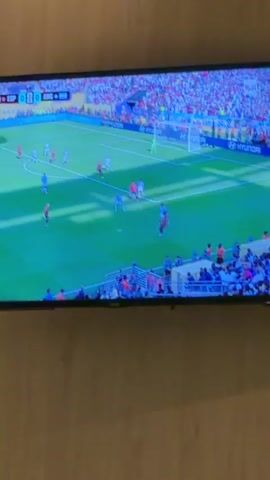 This is a short video of a television screen displaying a soccer match. The score is 0-0, with Spain (ESP) playing against Argentina (ARG). The time is 103 minutes and 16 seconds, indicating overtime. Players in red and blue jerseys are on the field. Spectators are visible in the stadium seating. The screen shows the top half of the field.