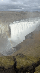 Visitors document Iceland's Dettifoss waterfall from multiple viewing angles