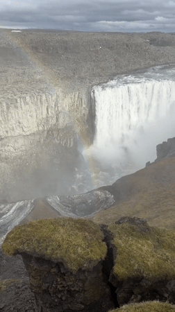 Visitors document Iceland's Dettifoss waterfall from multiple viewing angles