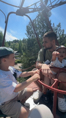 Families enjoy morning at Chaikovsky amusement park Ferris wheel
