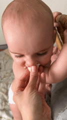 Baby fed banana pieces in Moscow feeding moment
