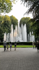 Lviv park afternoon: fountain sculptures, croissant café, summer strollers