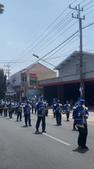 Multiple marching bands parade through Ngasem in a community celebration