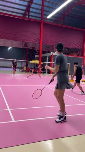 Badminton doubles match played on pink court in Ko Samui