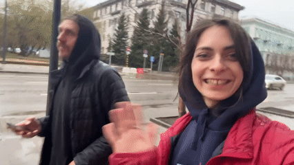 Woman films vlog outdoors in Krasnoyarsk on grey day