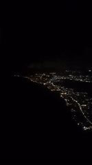 Aerial nighttime view captured of Indonesian coastal city