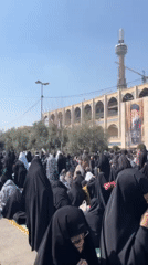 Women gather near religious building in Tehran public space