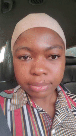 Woman in head covering recorded sitting in car, Nigeria