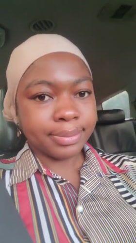 Woman in head covering recorded sitting in car, Nigeria