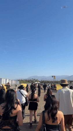 Festival crowd walks toward outdoor event in Indio