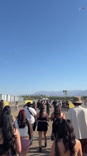 Festival crowd walks toward outdoor event in Indio