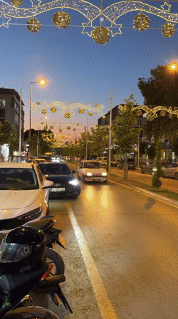 Festive string lights glow along an Osmaniye street at dusk