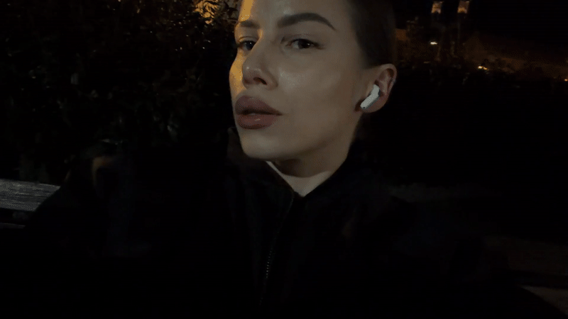 Person smoking cigarette at Gdańsk waterfront during evening hours