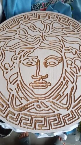 Nigerian Graphic Designer Documents Workspace and Handmade Versace Carving