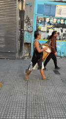 Street musicians perform while walking in Buenos Aires