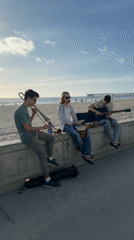 Three musicians perform impromptu beach concert in San Diego