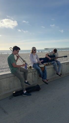 Three musicians perform impromptu beach concert in San Diego