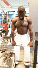 Barbell training session in the gym, mid-lift focus.