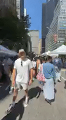 Street market bustles near colorful Love sculpture in NYC