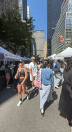 Street market bustles near colorful Love sculpture in NYC
