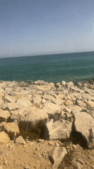Rocky coastline documented in Mataró with graffiti, fence visible