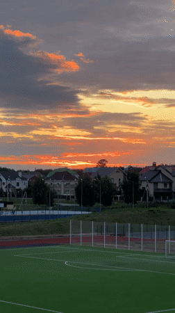 Evening life unfolds in Russian suburb during dramatic sunset
