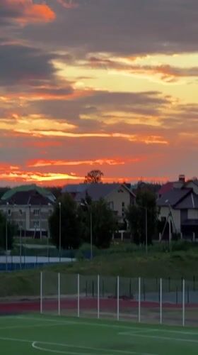 Evening life unfolds in Russian suburb during dramatic sunset