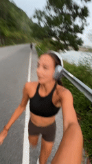 Morning jogger runs scenic waterfront route in Chalong, Thailand